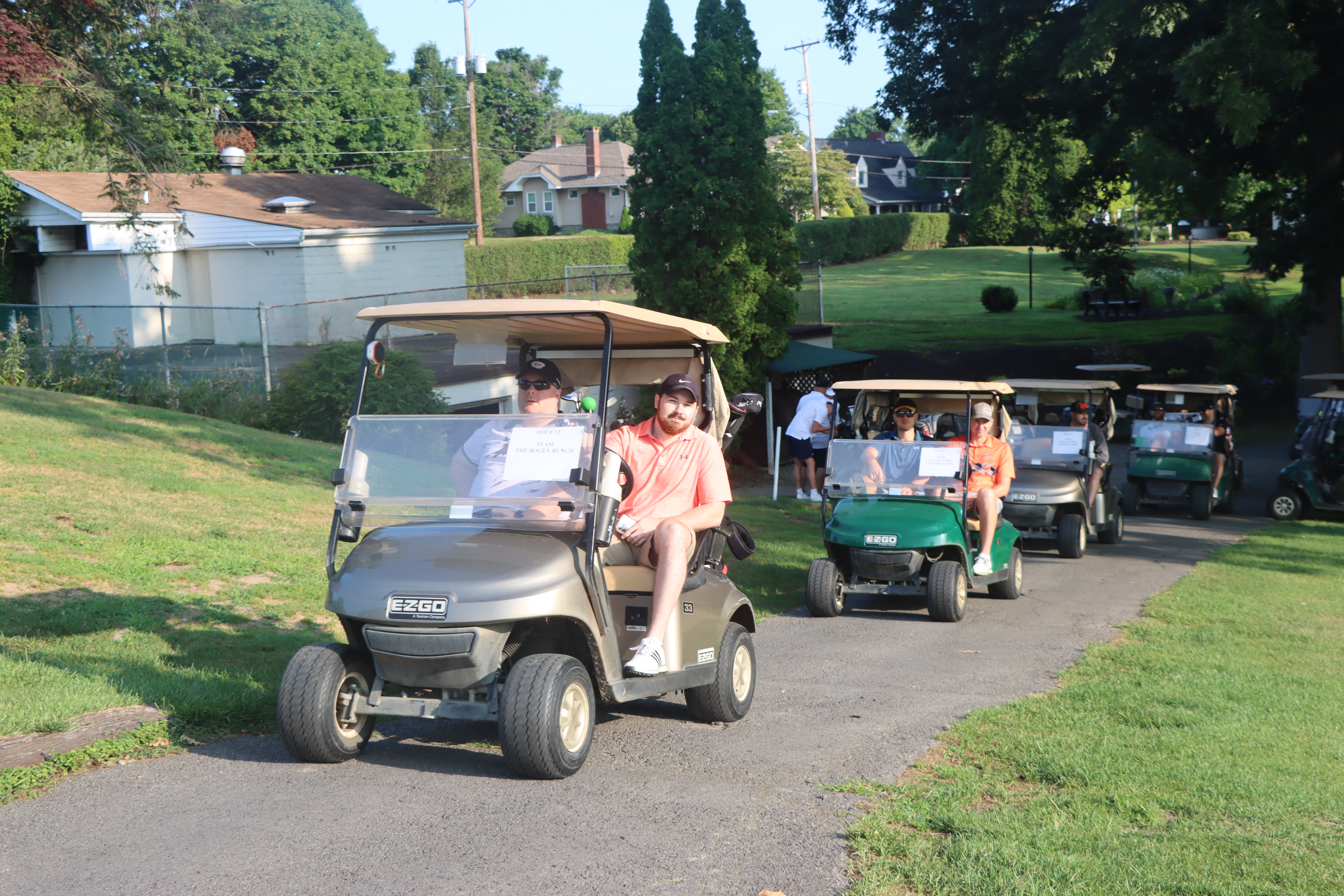 Golfers driving their carts.